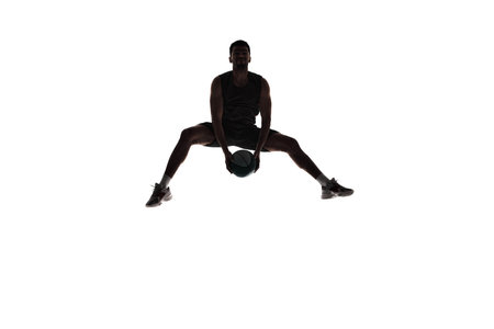 Silhouette of male athlete, basketball player in mid-air training, playing isolated on white background. Dynamicsの写真素材