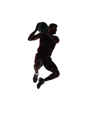 Silhouette of male basketball player in motion during game, training, playing isolated on white background. Full-lengthの写真素材