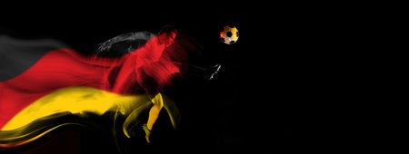 Concentrated and competitive man, football player in motion during game on black background with flag of Germany elementの写真素材