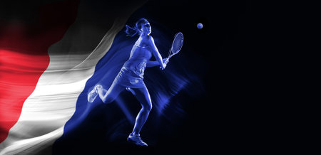 Concentrated young woman, tennis payer in motion, hitting all with racket on black background with flag of France elementの写真素材