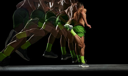 Muscular shirtless man is captured in motion, training, running against black background with stroboscope effectの写真素材