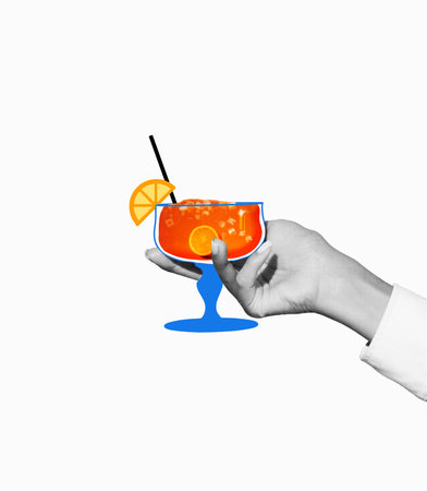 Cheers. Female holding glass with sweet and sour cocktail decorated with orange slice against light background. Creative colorful design.の写真素材