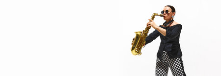 Woman, musician in a black and white outfit plays the saxophone with vibrant energy isolated on white backgroundの写真素材