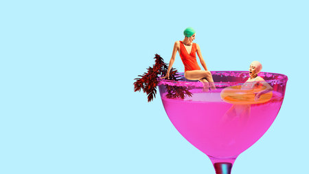 Two women in retro swimsuits relaxing inside pink cocktail against light blue background. Pool...
