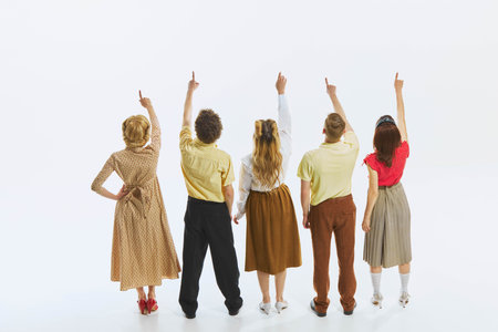 Five people, women and men, standing in row, facing and pointing upwards. Announcement, goals, news,...