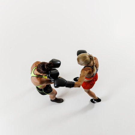 Female boxers exchange blows, showcasing strength and agility, two woman training with intensity isolated on white backgroundの写真素材