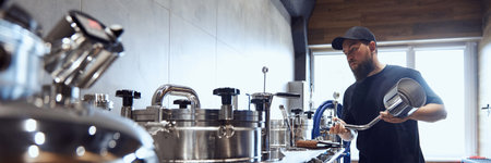 Bearded man, technologist expertly checking brewing equipment, showing meticulous attention to...
