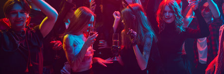 Lemonade, dances and laugh. Group of people, friends gathering at nightclub to celebrate Halloween. Wearing costumes and makeup of supernatural charactersの写真素材