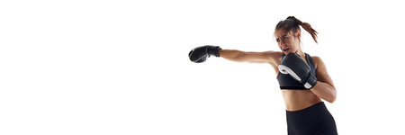 Jab punch. Powerful and emotional young woman, boxing athlete in motion, fighting isolated on white...