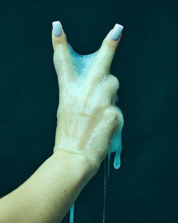 Female hand covered in slime, gesturing against cyan green background. Sci-fi horror movie poster...