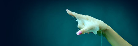 Female hand covered in slime, gesturing against cyan green background. Haunted flyers, Halloween...