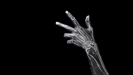 Trick or treat game. Human hand painted as skeleton gesturing against black background.の写真素材