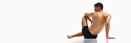Back view image of young man with strong, muscular body, relief back posing in underwear isolated on...