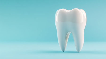 single, perfect white tooth against soft blue background. Goal of healthy, well-maintained teeth in dentistry.の写真素材