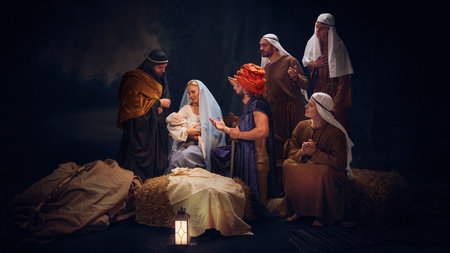 The wise men and shepherds gathering around Mary and baby Jesus, offering gifts and prayers. Holiness of sacred night.の写真素材