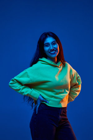 against blue studio background in neon lightの写真素材