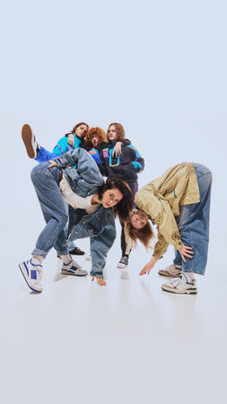 Nostalgic vibe. Young people in their 20s wearing 90s style urban outfits and posing with against white studio background. Oversized jackets and jeansの写真素材