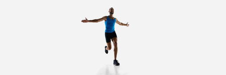 Champion. Athletic, determined man, runner winning marathon isolated on white studio background