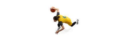 Top view image of female basketball player in yellow jersey dribbling, training isolated on white backgroundの写真素材