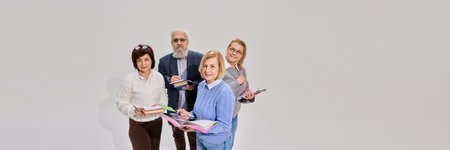 Positive elderly people, man and woman standing with books and notes against white background....