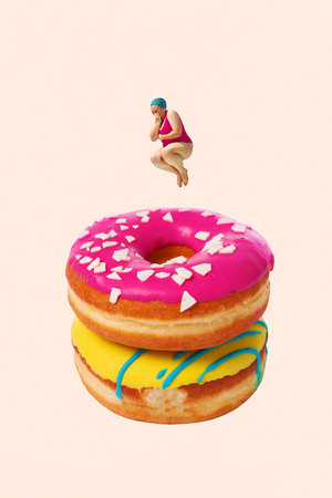 Woman in swimsuit jumping into stacked donuts with colorful icing against pastel background. Contemporary art collage.の写真素材