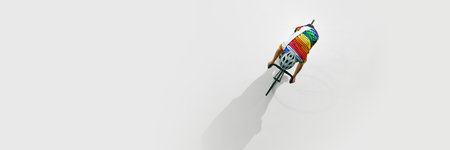 Aerial view of male cyclist in colorful uniform and helmet, in motion on bicycle, riding isolated on white background.の写真素材