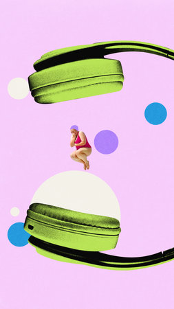 Woman in swimsuit jumping on giant headphones with colorful circles backdrop.の写真素材