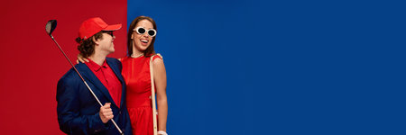 Man holding golf club and smiling at woman in red dress laughing, wearing white sunglasses on colorful split background.の写真素材