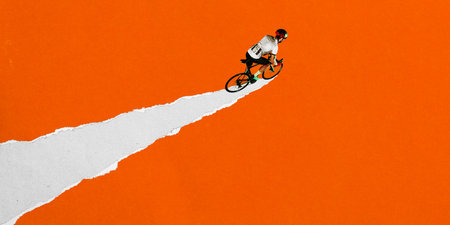 Male cyclist speeds forward on torn white road across vibrant orange background. Dynamic graphic design. Concept of sport, game, competition, endurance, road cyclingの写真素材
