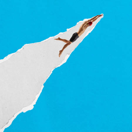 Male swimmer dives downward on a diagonal torn paper stripe against a blue background. Cutout textured collageの写真素材