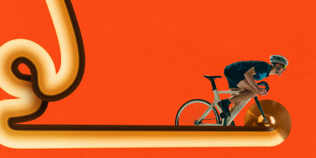 Rider speeds forward on golden cymbal as wheel across surreal path on bright orange background. Stretch effect. Banner.の写真素材