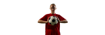 Female football player holding ball with calm confidence looking forward during pause between actions against white background. Banner.の写真素材