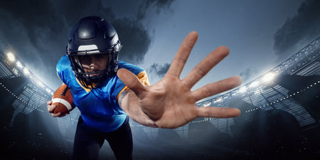American football player in helmet extends hand in defense at 3D stadium. Athlete performanceの写真素材