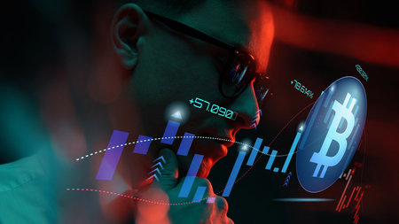 Trader analyzing bitcoin market trends on digital screen in dimly lit environment with red lightingの写真素材