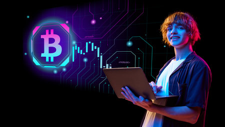 Young person analyzing cryptocurrency data on laptop with bitcoin symbol in futuristic settingの写真素材