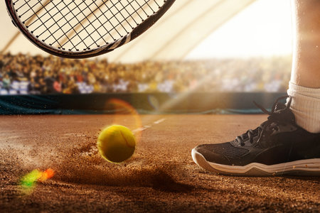 Tennis ball hitting clay court during match on 3D tennis stadiumの写真素材