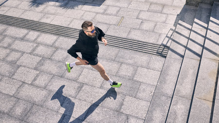 Man jogging on sunny day showcases commitment to midlife fitness and healthy lifestyle