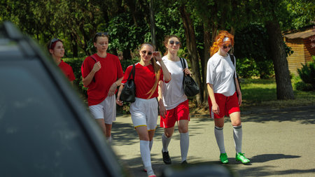 Women football team walking together after practice on sunny day