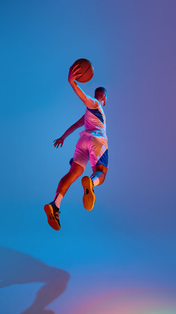 Basketball player in mid-air leap against vibrant blue backdrop