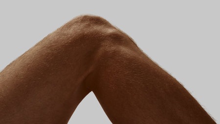 Cropped view of bent male knee in natural relaxed position
