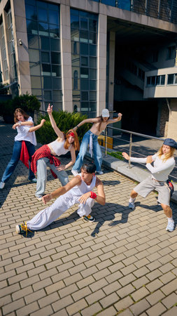 Redhead female dancer leading group with strong expression and stylish urban movesの写真素材