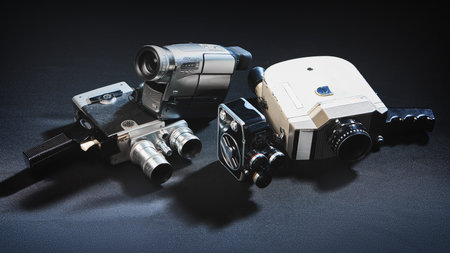 Collection of vintage and retro video cameras on dark surface