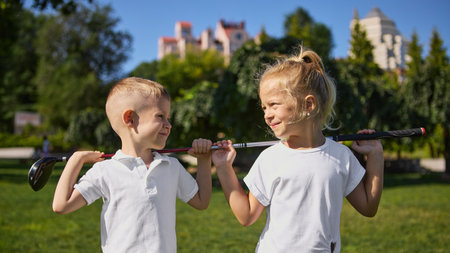 Kids playing golf with joyful teamwork outdoorsの写真素材