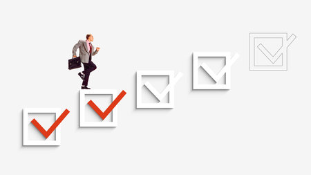 Poster with businessman stepping on checkmarks toward progress and successの写真素材