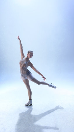 Female skater balancing with extended leg in soft white illuminated arena