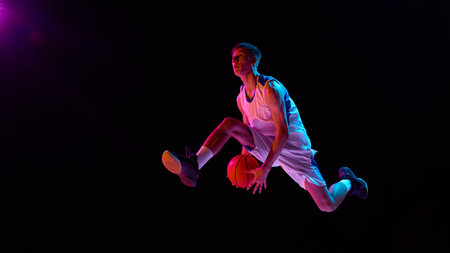 Basketball player flying mid air neon lights action and emotionの写真素材