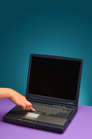 Female hand touching retro laptop touchpad with emotional curiosity and lifestyle charm