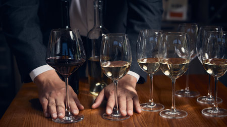 Sommelier comparing red and white wines during elegant tasting session
