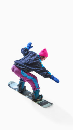 Snowboarder in colorful outfit balancing on snowboard isolated on white backgroundの写真素材