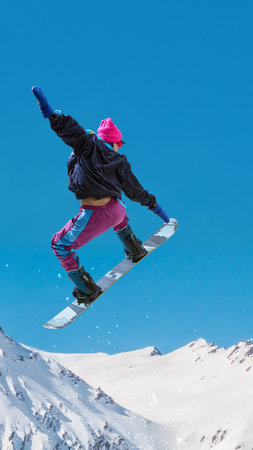 Snowboarder jumping above snowy mountains under clear blue winter sky. Handmade collageの写真素材